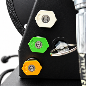 White, green, and yellow pressure washer spray nozzles attached to the side of a Paddock™ 1,450 PSI Wall Mountable Pressure Washer with Hose Reel.